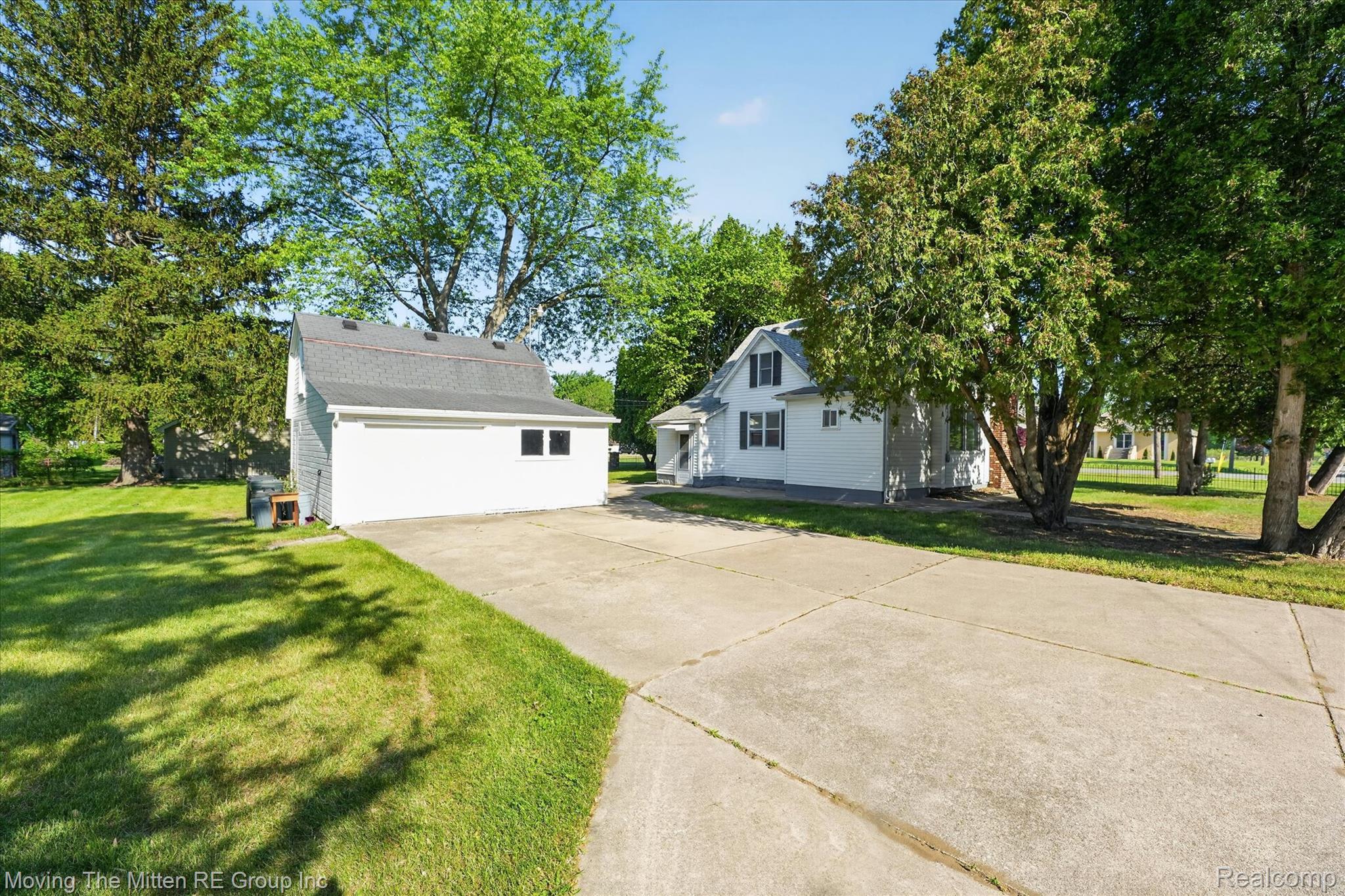 25505 Wick Road Taylor, MI 48180 - Photo 42 of 68 View of property exterior featuring a lawn, an outbuilding, and concrete driveway