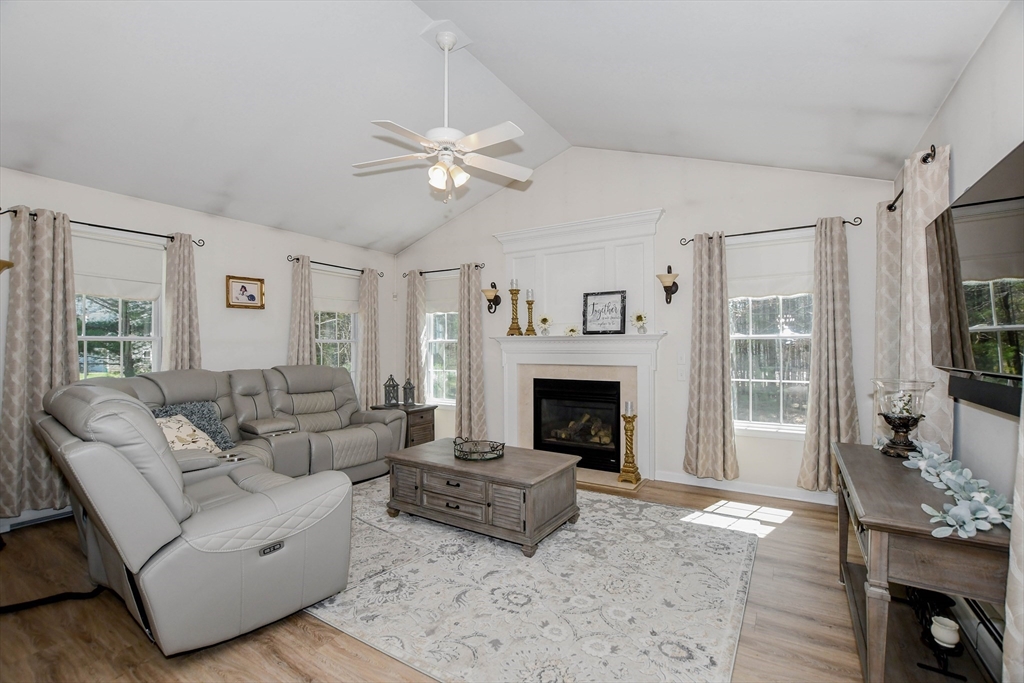 57 Harvest Circle Wareham, MA 02576 - Photo 11 of 39 a living room with furniture a fireplace and a flat screen tv