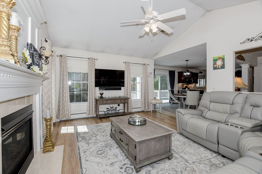 57 Harvest Circle Wareham, MA 02576 - Photo 13 of 39 a living room with furniture a flat screen tv and a fireplace