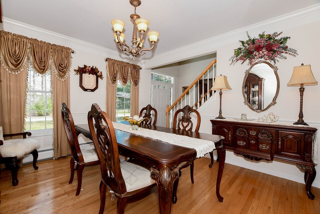 57 Harvest Circle Wareham, MA 02576 - Photo 17 of 39 a view of a dining room with furniture a chandelier and a window