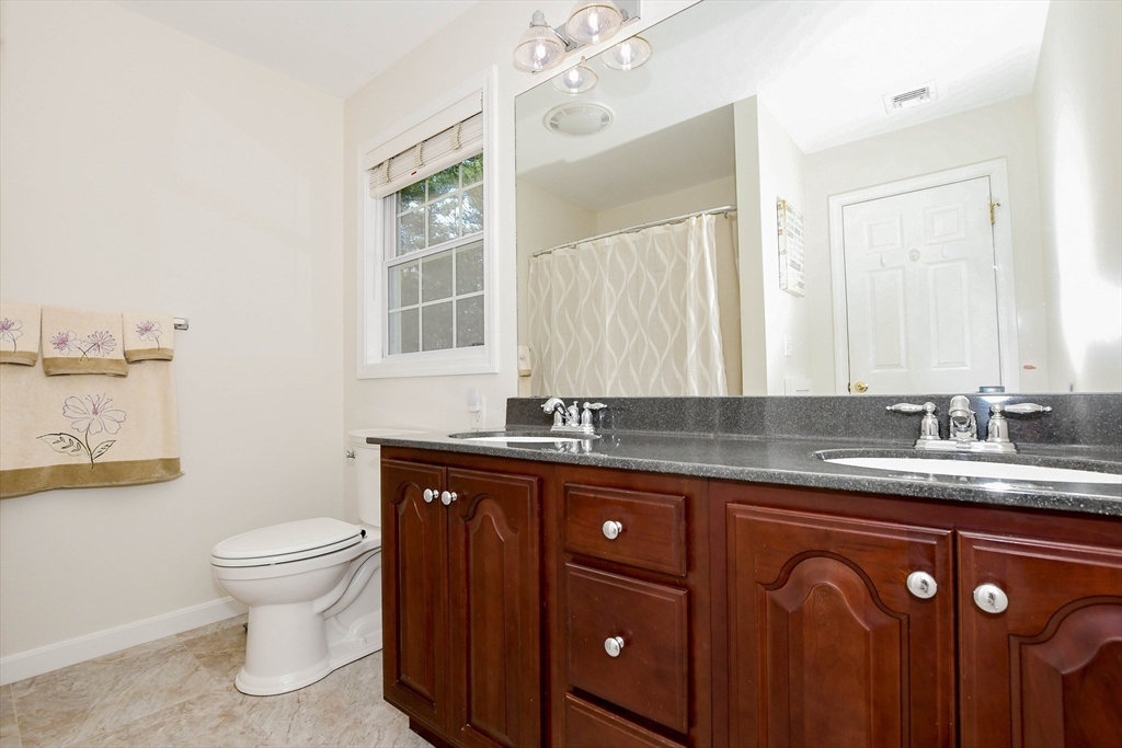 57 Harvest Circle Wareham, MA 02576 - Photo 22 of 39 a bathroom with a granite countertop sink a toilet and a mirror