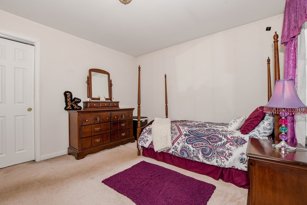 57 Harvest Circle Wareham, MA 02576 - Photo 27 of 39 a bedroom with a bed and a dresser