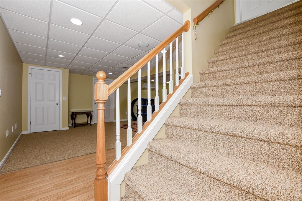 57 Harvest Circle Wareham, MA 02576 - Photo 28 of 39 a view of staircase with lots of frames and a rug