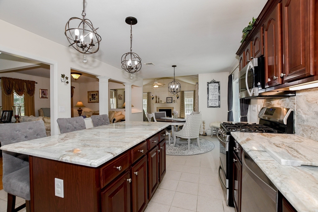 57 Harvest Circle Wareham, MA 02576 - Photo 8 of 39 a kitchen with center island table and chairs