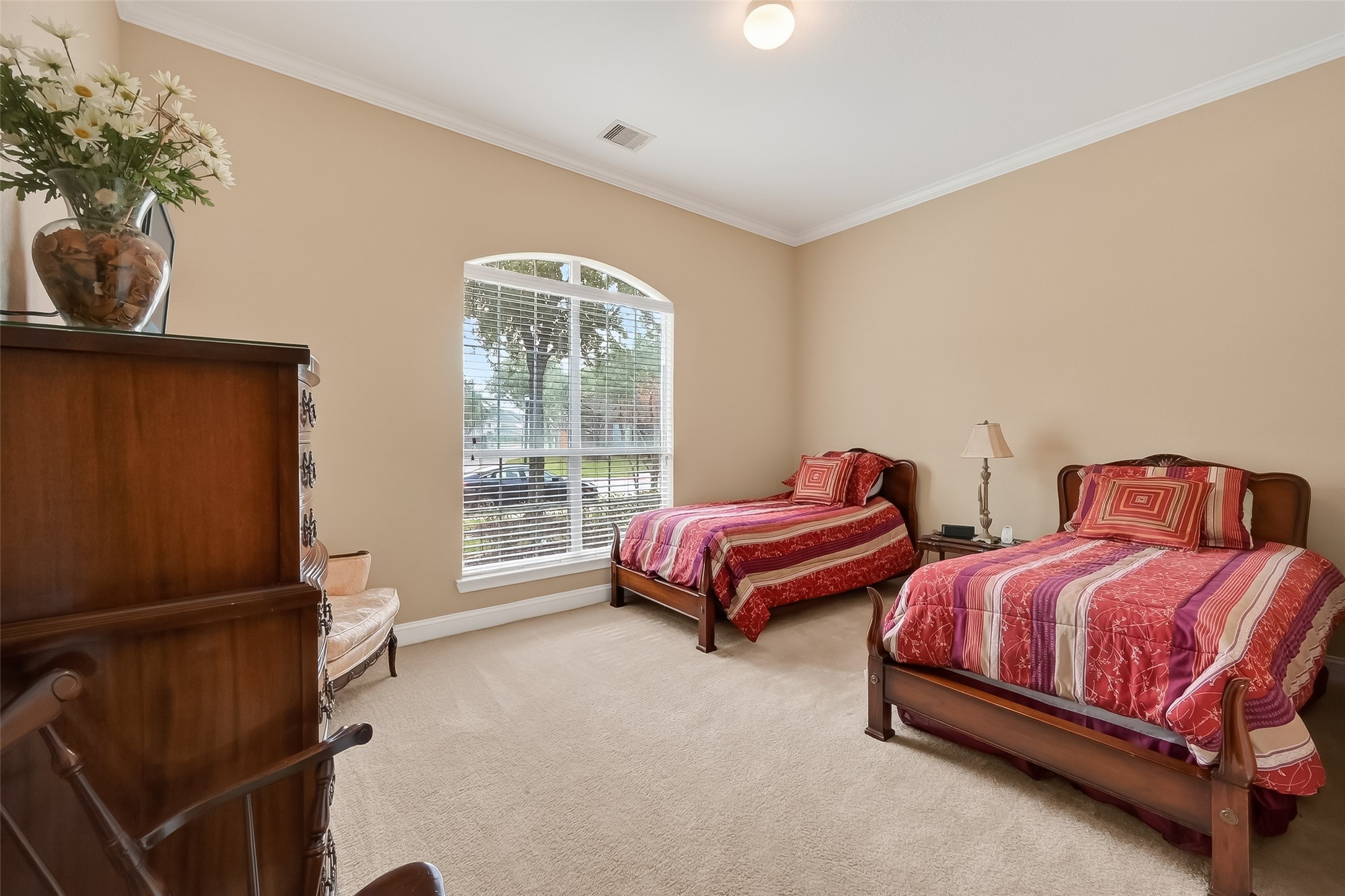 18622 Yorkshire Manor Court Spring, TX 77379 - Photo 16 of 49 a bedroom with two beds and potted plant next to a window