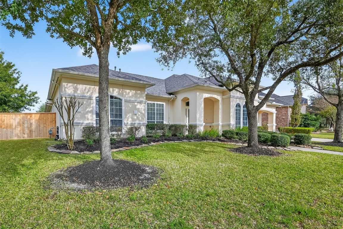 18622 Yorkshire Manor Court Spring, TX 77379 - Photo 2 of 41 a front view of a house with a garden and trees