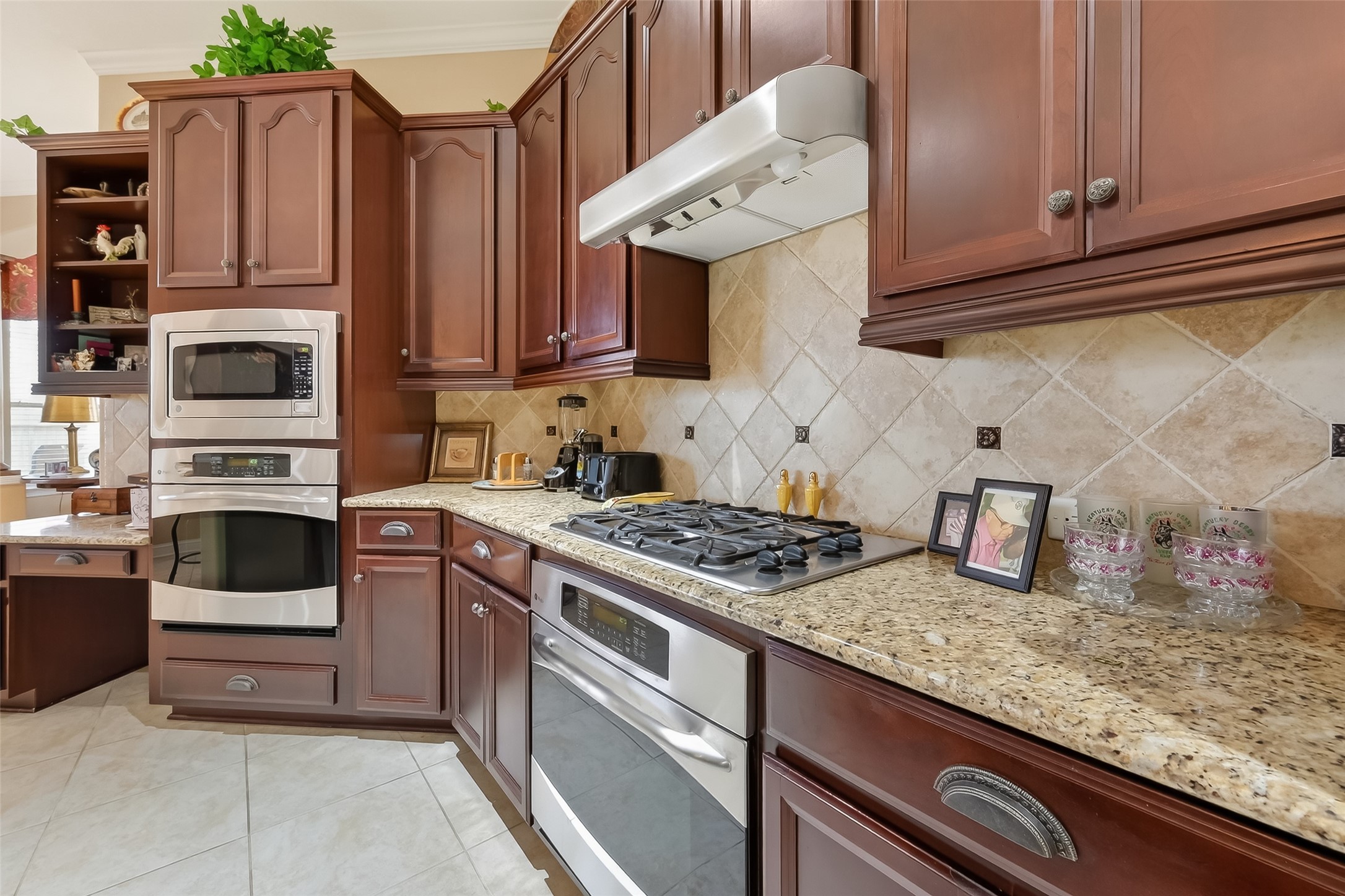 18622 Yorkshire Manor Court Spring, TX 77379 - Photo 23 of 41 a kitchen with granite countertop a stove sink and cabinets