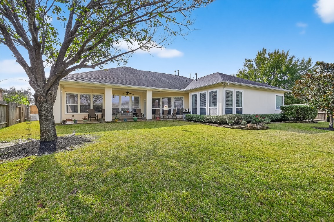 18622 Yorkshire Manor Court Spring, TX 77379 - Photo 37 of 41 a front view of a house with a yard table and chairs