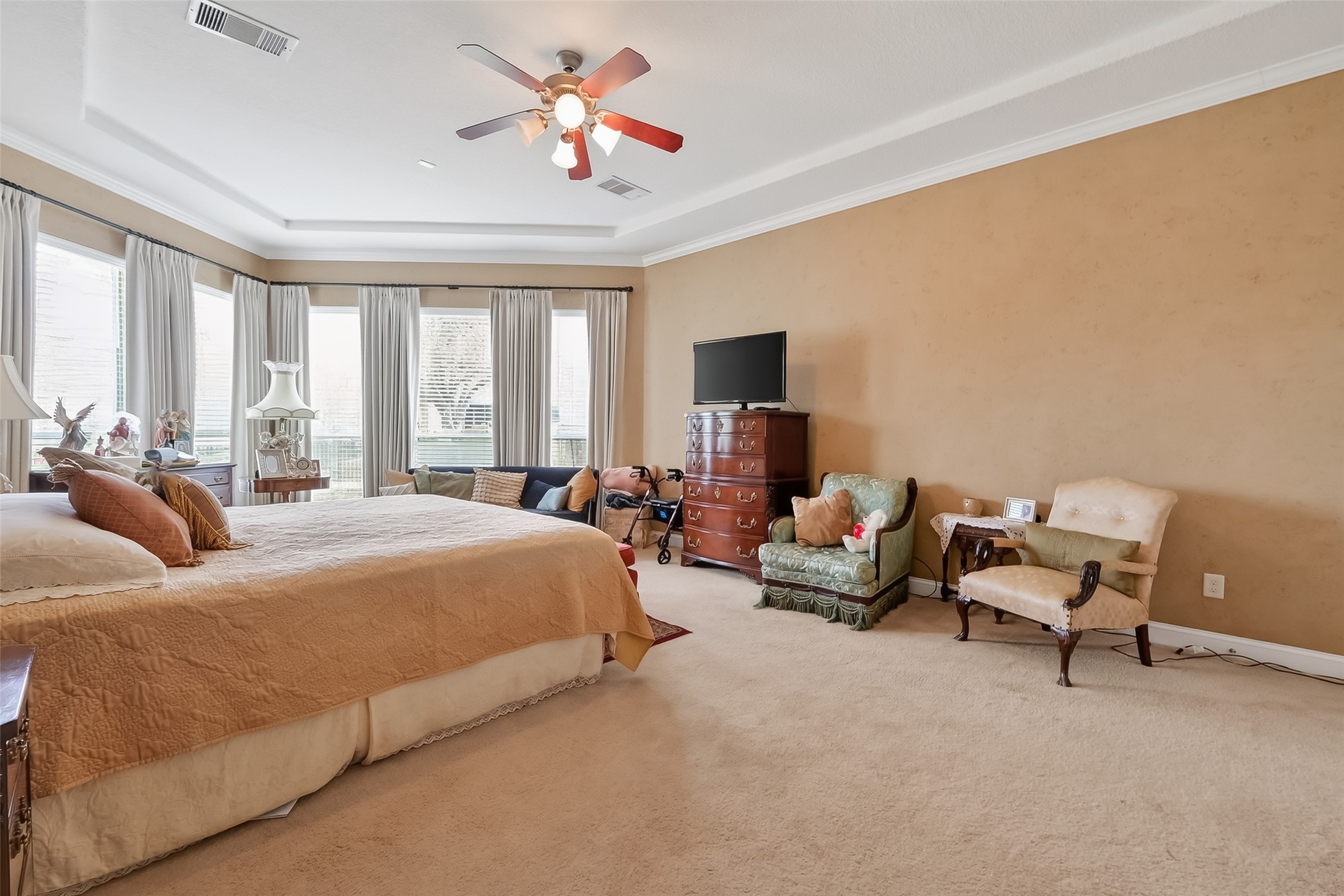 18622 Yorkshire Manor Court Spring, TX 77379 - Photo 38 of 49 a spacious bedroom with a bed a couch and a flat tv screen