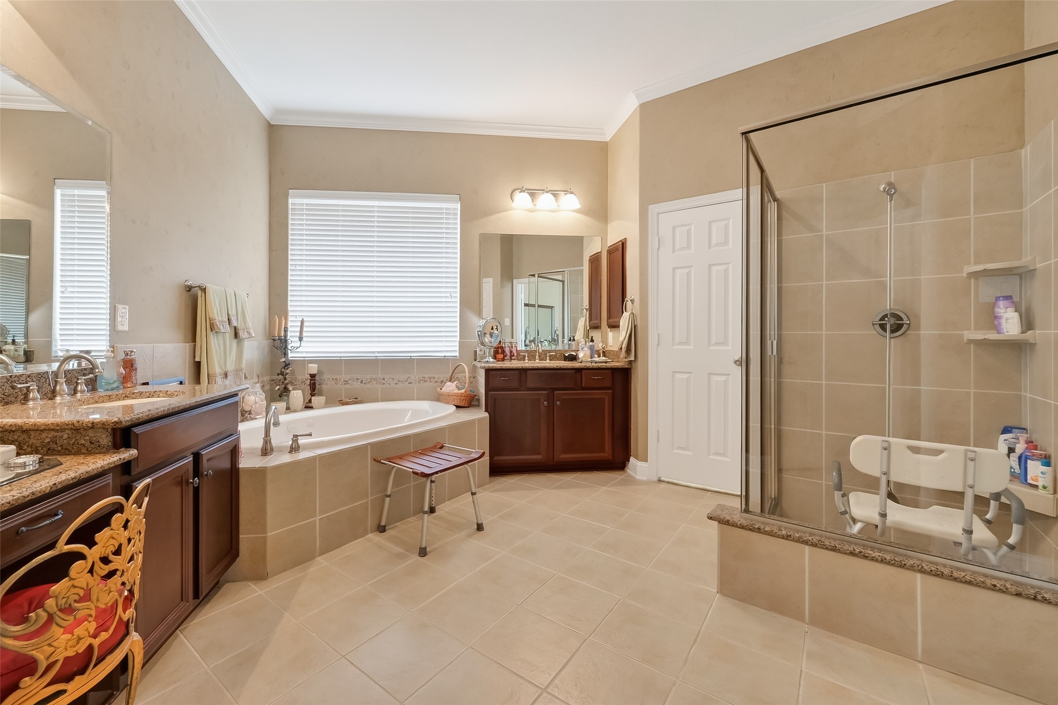 18622 Yorkshire Manor Court Spring, TX 77379 - Photo 41 of 49 a bathroom with a granite countertop double vanity sink a mirror and a bathtub