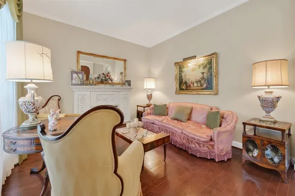 a view of a dining room with furniture a chandelier and wooden floor