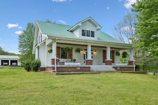 a view of a house with a yard patio and swimming pool