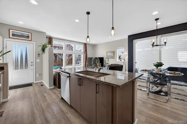 a kitchen with stainless steel appliances granite countertop sink stove top oven and cabinets