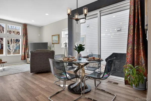 a dining room with furniture and wooden floor