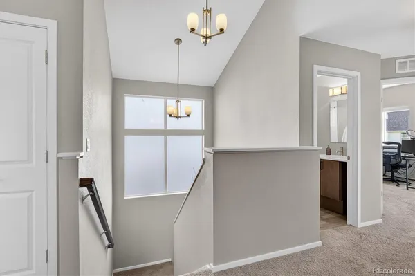 a view of a hallway with a chandelier