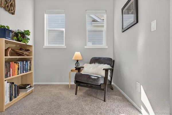 a living room with furniture and a book shelf