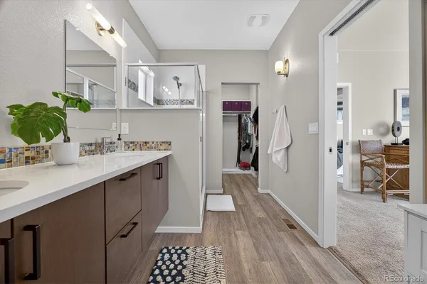 a kitchen with stainless steel appliances a sink cabinets and wooden floor