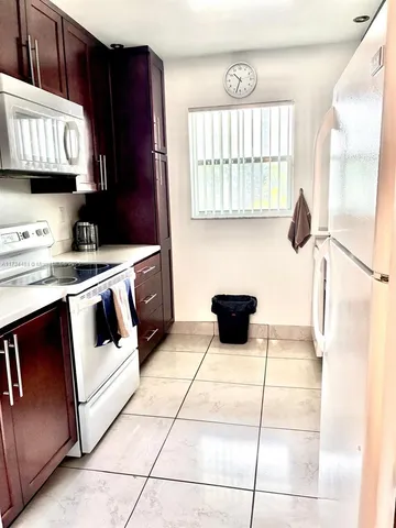 a picture of a building with a lot of plants and flowers