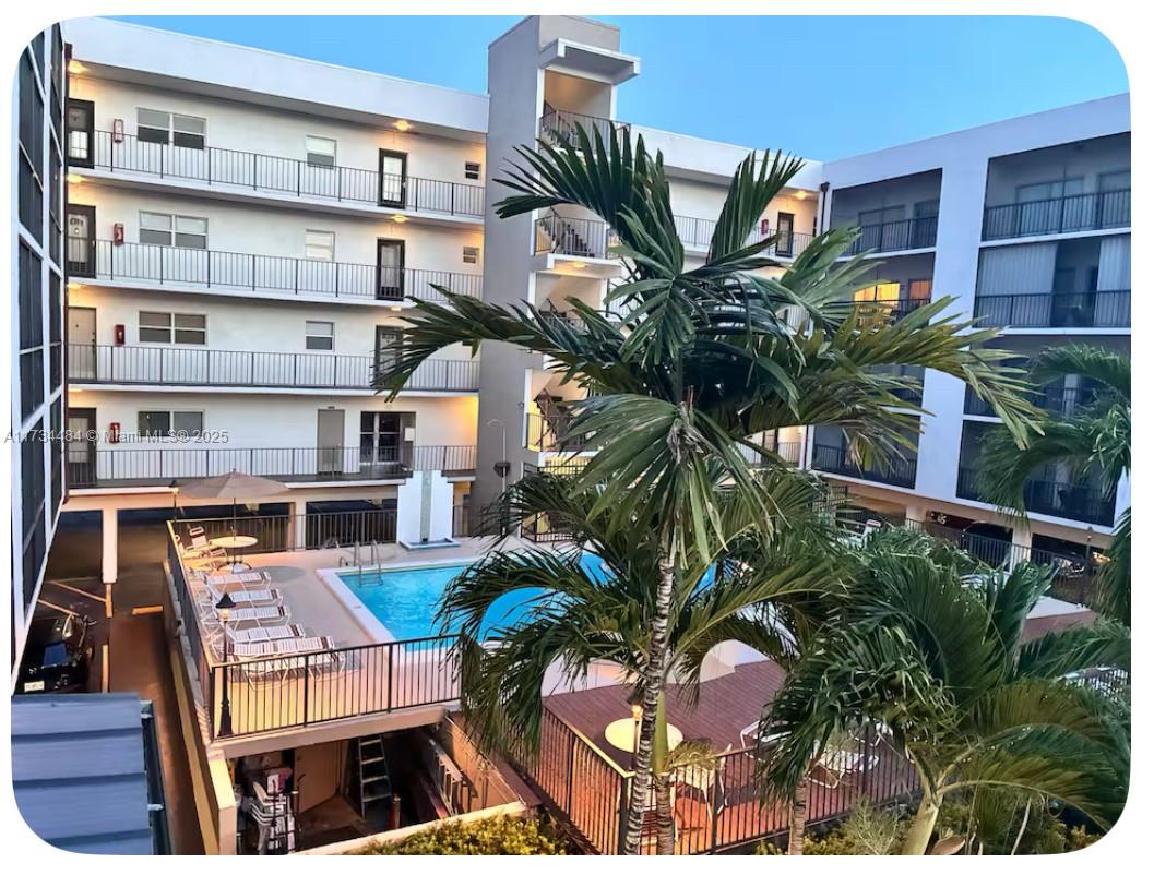201 178th Drive, Unit 331 Sunny Isles Beach, FL 33160 - Photo 14 of 27 a picture of a building with a lot of plants and flowers
