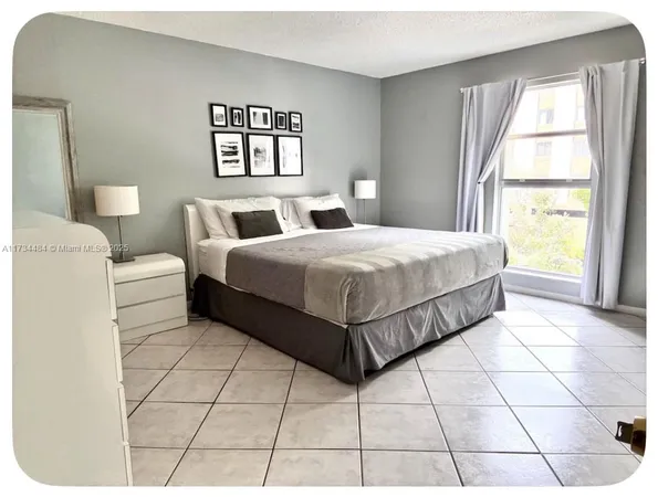 a bedroom with a bed and a mirror