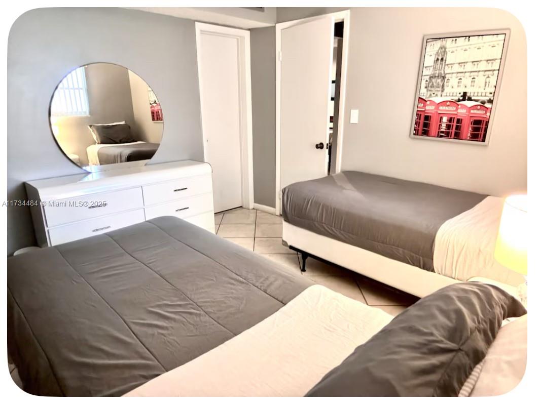 201 178th Drive, Unit 331 Sunny Isles Beach, FL 33160 - Photo 27 of 27 a bedroom with a large bed and a mirror