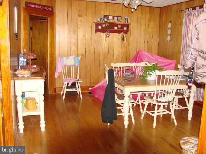 3002 Ritchie Avenue Sparrows Point, MD 21219 - Photo 11 of 15 a dining room with wooden floor table and chairs