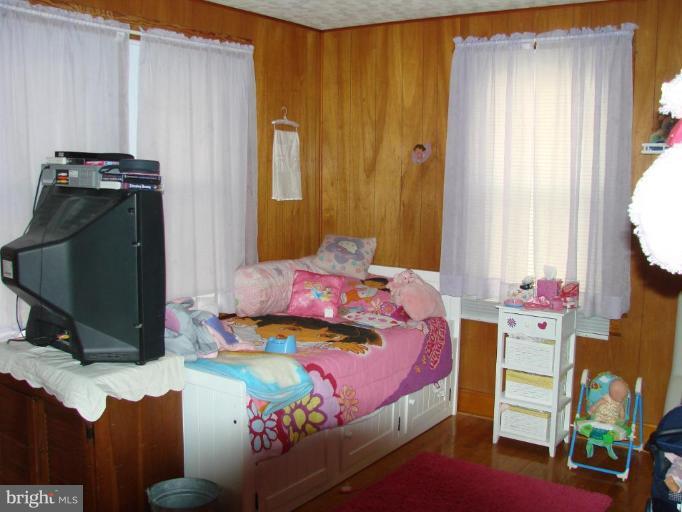 3002 Ritchie Avenue Sparrows Point, MD 21219 - Photo 13 of 15 a bedroom with a bed closet and a window