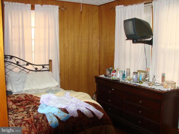 3002 Ritchie Avenue Sparrows Point, MD 21219 - Photo 14 of 15 a bedroom with a bed and a window
