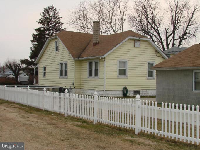 3002 Ritchie Avenue Sparrows Point, MD 21219 - Photo 3 of 15 a view of a white house that has a small yard and a large tree