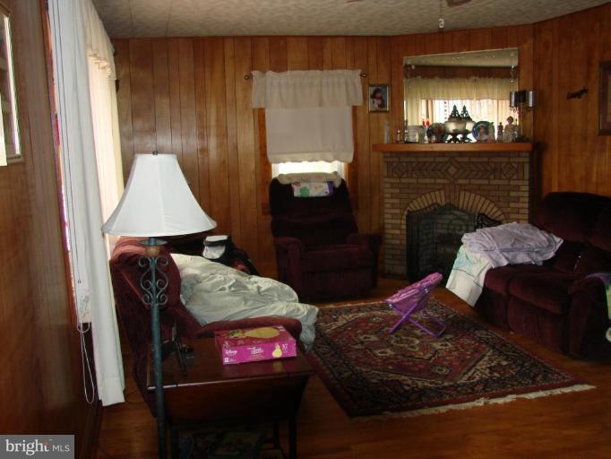 3002 Ritchie Avenue Sparrows Point, MD 21219 - Photo 9 of 15 a living room with furniture and a fireplace