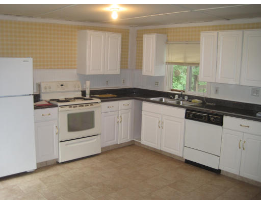 71 Great Road Shirley, MA 01464 - Photo 3 of 30 a kitchen with white cabinets appliances and a sink