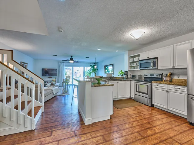a view of staircase with wooden floor and a rug