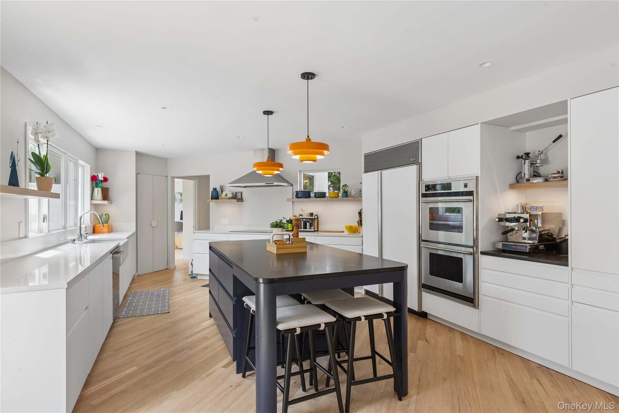 2 Acorn Path Quogue, NY 11959 - Photo 5 of 16 Newly renovated Contemporary kitchen featuring light wood-finish flooring, convection burners, and a central island