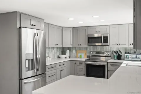a kitchen with cabinets stainless steel appliances and a sink