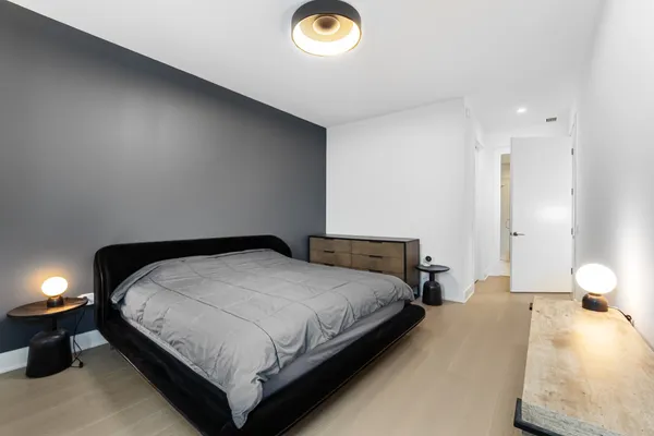 a bedroom with a bed and a lamp