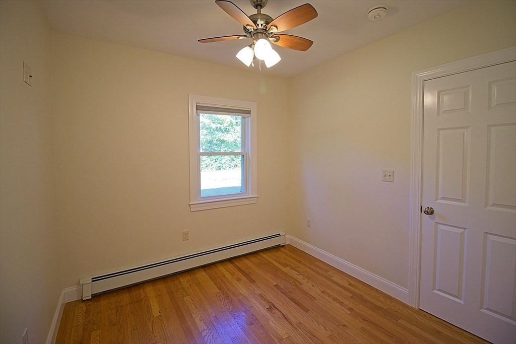 40 Quincy Street, Unit B Sharon, MA 02067 - Photo 4 of 10 a view of an empty room with window and wooden floor