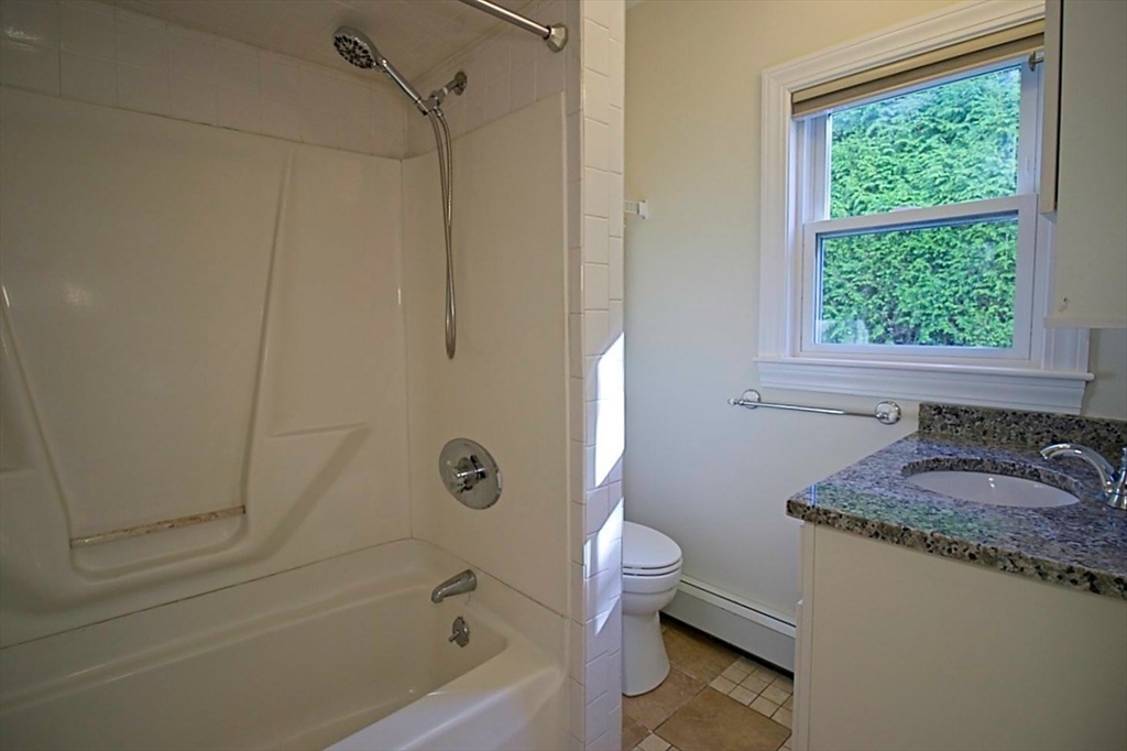 40 Quincy Street, Unit B Sharon, MA 02067 - Photo 5 of 10 a bathroom with a granite countertop sink a toilet and shower