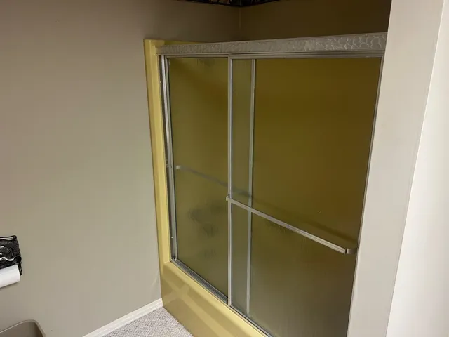 a bathroom with a glass door