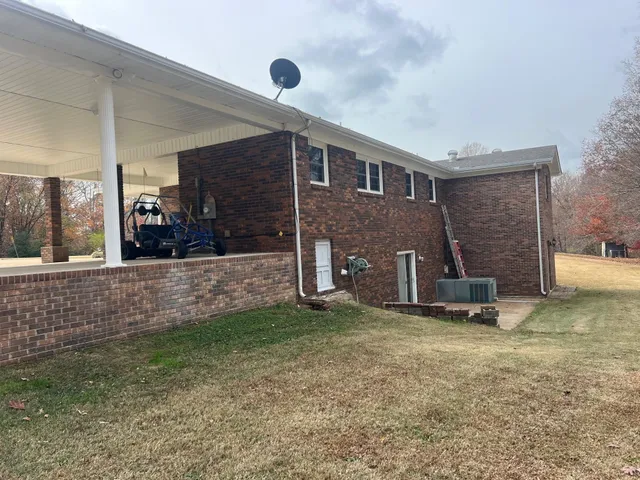 a view of a house with a yard and porch
