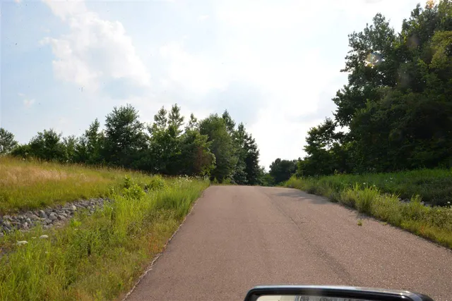 a view of a house with a yard and garage