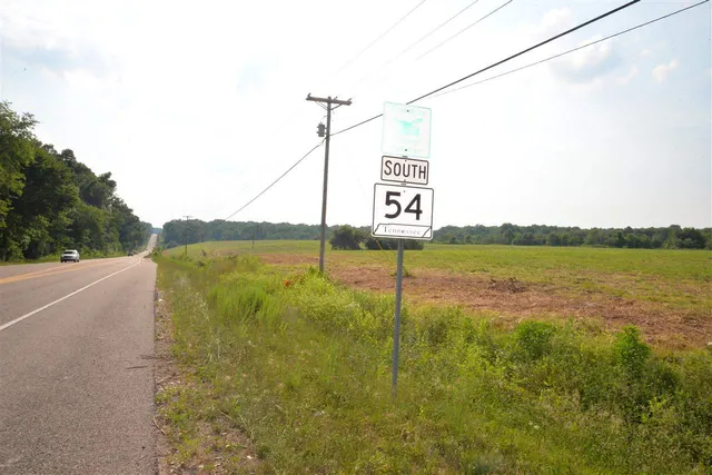 a view of a street with a building in the background