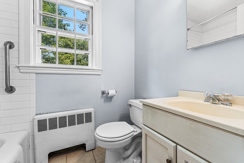 7 Spring Street Lexington, MA 02421 - Photo 11 of 25 a bathroom with a sink a toilet and a window