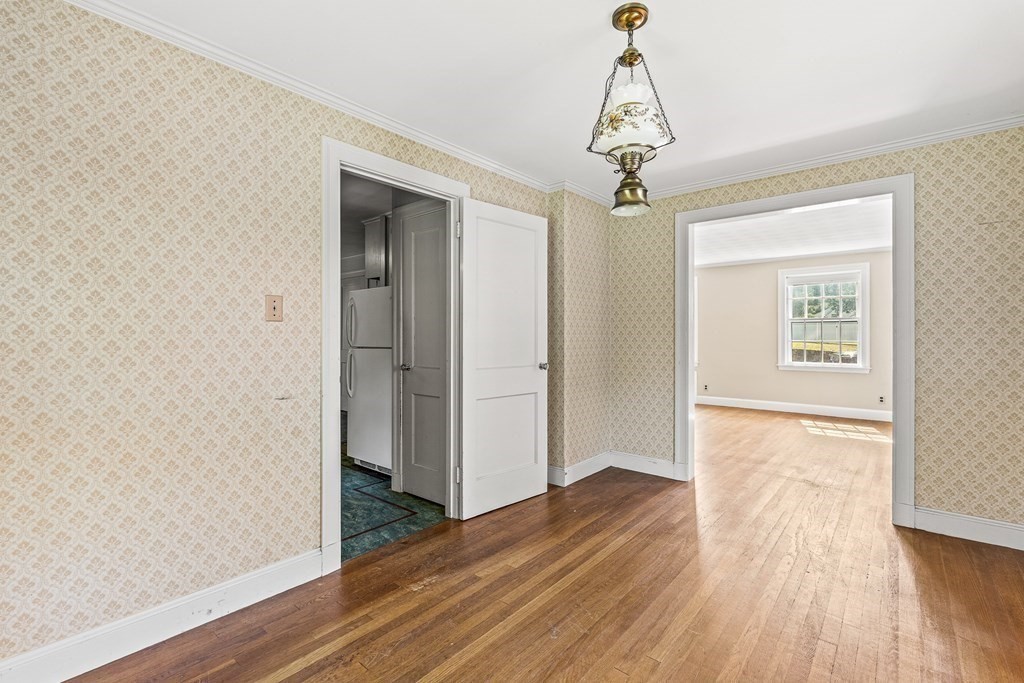 7 Spring Street Lexington, MA 02421 - Photo 12 of 25 a view of empty room with wooden floor and ceiling fan