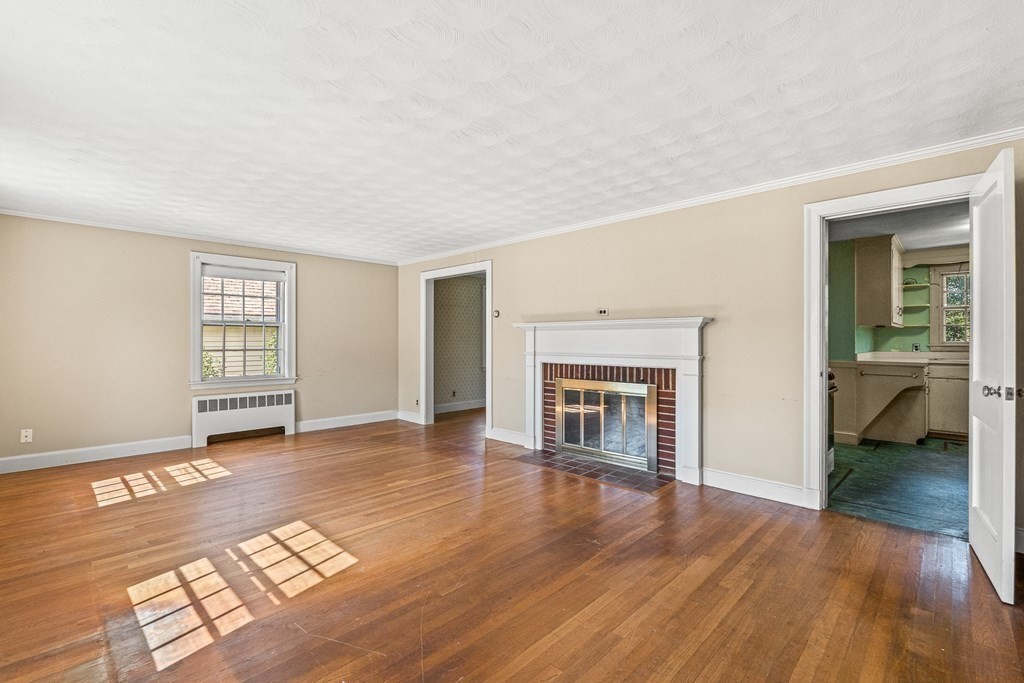 7 Spring Street Lexington, MA 02421 - Photo 13 of 25 an empty room with windows and fireplace