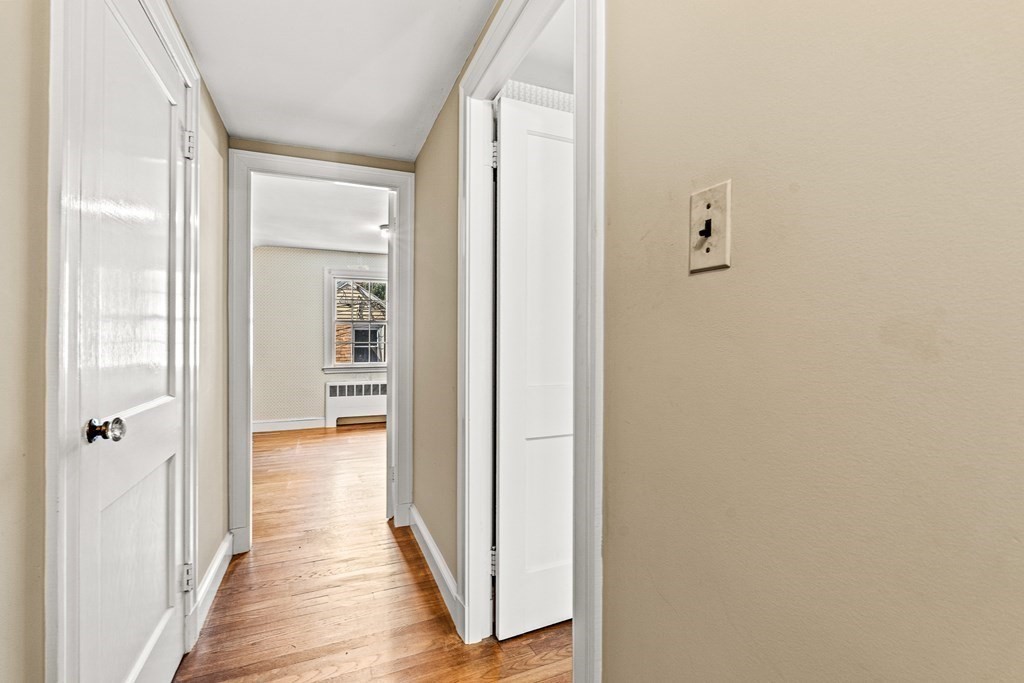 7 Spring Street Lexington, MA 02421 - Photo 14 of 25 a view of a hallway with wooden floor and closet