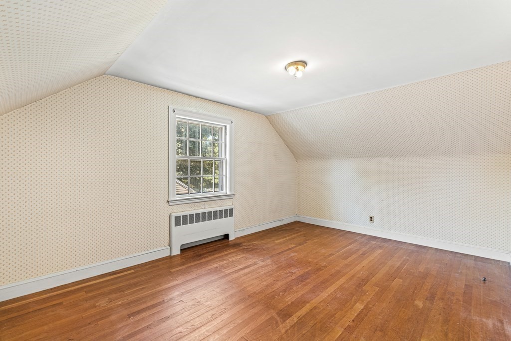 7 Spring Street Lexington, MA 02421 - Photo 19 of 25 an empty room with wooden floor and windows