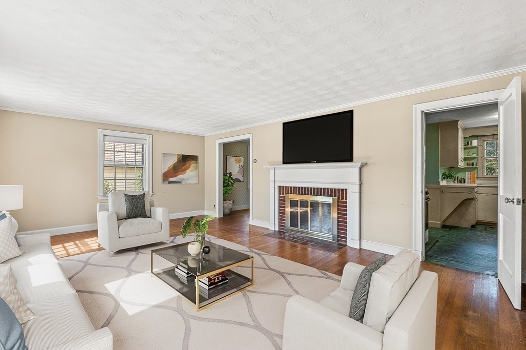 7 Spring Street Lexington, MA 02421 - Photo 2 of 25 a living room with furniture a fireplace and a flat screen tv