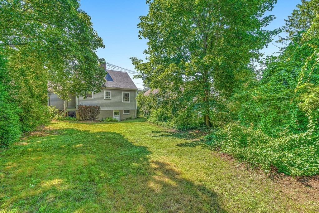 7 Spring Street Lexington, MA 02421 - Photo 23 of 25 a view of a house with a big yard and large trees
