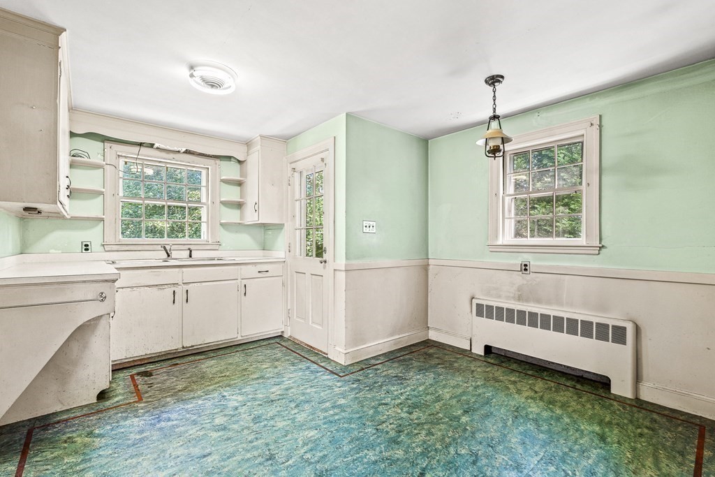7 Spring Street Lexington, MA 02421 - Photo 7 of 25 a bathroom with a sink window and a mirror