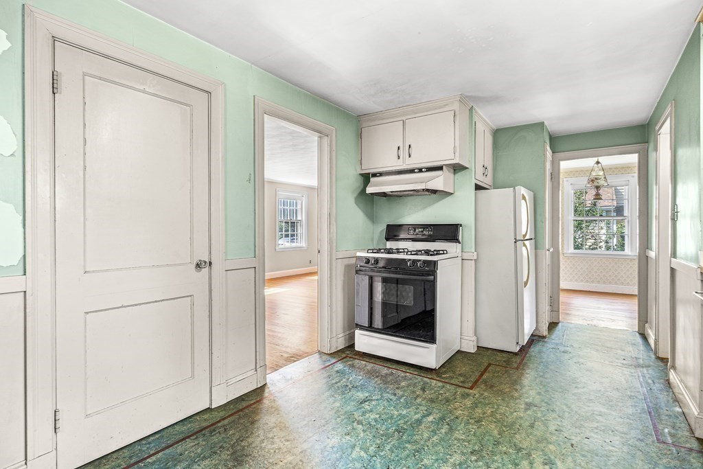 7 Spring Street Lexington, MA 02421 - Photo 9 of 25 a kitchen with stainless steel appliances a refrigerator sink and cabinets